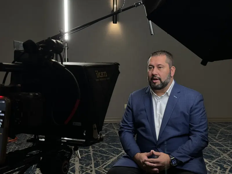Camera, teleprompter, and lighting arranged for a seated interview